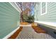 Paver walkway through the side yard of home with green siding at 1504 Galloway Ln, Charleston, SC 29412
