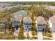 Aerial view of a scenic community featuring homes, a pond with a fountain, and lush landscaping, creating a peaceful atmosphere at 1537 Cultivation Ln, Mount Pleasant, SC 29466