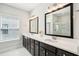 Bathroom boasts a double vanity with dark cabinets, bright countertops, and recessed lighting at 1537 Cultivation Ln, Mount Pleasant, SC 29466