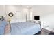 Bright bedroom featuring hardwood floors, white walls, a metal bed frame, and neutral decor at 1537 Cultivation Ln, Mount Pleasant, SC 29466