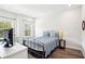 Bedroom with wood floors, light walls, and a vintage-style bed with a blue quilt at 1537 Cultivation Ln, Mount Pleasant, SC 29466
