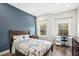 Charming bedroom featuring a blue accent wall, wood floors, desk and modern decor at 1537 Cultivation Ln, Mount Pleasant, SC 29466