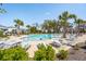 Spacious community pool with ample lounge chairs, umbrellas, and lush greenery, providing a perfect spot for relaxation and leisure at 1537 Cultivation Ln, Mount Pleasant, SC 29466