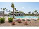 Large community pool area with lounge chairs, palm trees, and a modern clubhouse, offering a resort-style living experience at 1537 Cultivation Ln, Mount Pleasant, SC 29466