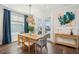 Inviting dining area with stylish lighting, wood table and seating, and views of the outdoors at 1537 Cultivation Ln, Mount Pleasant, SC 29466
