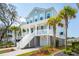Charming coastal home with light blue siding, white trim, and inviting front porch with palm trees at 1537 Cultivation Ln, Mount Pleasant, SC 29466