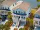 Beautiful two-story coastal home with a metal roof, front porch, palm trees, and a two-car garage at 1537 Cultivation Ln, Mount Pleasant, SC 29466