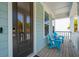 Welcoming front porch featuring blue Adirondack chairs, a stylish front door, and charming coastal details at 1537 Cultivation Ln, Mount Pleasant, SC 29466