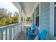 Relaxing front porch with comfortable blue Adirondack chairs, perfect for enjoying the outdoors at 1537 Cultivation Ln, Mount Pleasant, SC 29466