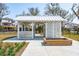 Charming white gazebo with seating areas, surrounded by landscaping, ideal for relaxation and outdoor gatherings at 1537 Cultivation Ln, Mount Pleasant, SC 29466