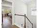 Hallway with wood floors and wooden railing with bedroom in the background at 1537 Cultivation Ln, Mount Pleasant, SC 29466