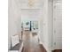 Inviting hallway with hardwood floors leading to a sunlit living area, showcasing the home's open layout at 1537 Cultivation Ln, Mount Pleasant, SC 29466