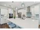 Bright, open kitchen with white cabinets, stainless appliances, and a large center island with stool seating at 1537 Cultivation Ln, Mount Pleasant, SC 29466