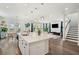 Kitchen island with white countertops open to the dining room and living room with ample natural light at 1537 Cultivation Ln, Mount Pleasant, SC 29466