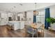 Kitchen and dining area with modern appliances, white cabinets, a spacious island, and contemporary decor at 1537 Cultivation Ln, Mount Pleasant, SC 29466