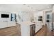 Open-concept kitchen featuring a center island and a view of the staircase and living room at 1537 Cultivation Ln, Mount Pleasant, SC 29466