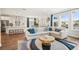 Open-concept living room with modern decor, connecting to a spacious kitchen with white cabinets and stainless steel appliances at 1537 Cultivation Ln, Mount Pleasant, SC 29466