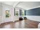 Versatile living room with wainscoting, a piano, and large windows providing a bright and airy atmosphere at 1537 Cultivation Ln, Mount Pleasant, SC 29466