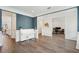 Elegant living room with hardwood floors, wainscoting, and white piano, offering a blend of sophistication and comfort at 1537 Cultivation Ln, Mount Pleasant, SC 29466