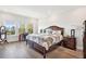Well-lit main bedroom with wooden floors, a desk and bedside table at 1537 Cultivation Ln, Mount Pleasant, SC 29466