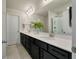 Bathroom with double vanity, black cabinets, quartz countertops, and a glass-enclosed shower at 163 Cypress Plantation Rd, Moncks Corner, SC 29461