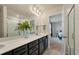 Bathroom with double vanity, black cabinets, quartz countertops, and a glass-enclosed shower, leading to bedroom at 163 Cypress Plantation Rd, Moncks Corner, SC 29461