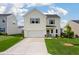Charming two-story home featuring a two-car garage, manicured lawn, and inviting curb appeal at 163 Cypress Plantation Rd, Moncks Corner, SC 29461