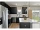 Modern kitchen featuring stainless steel appliances, dark cabinets, and a spacious island with a white countertop at 163 Cypress Plantation Rd, Moncks Corner, SC 29461