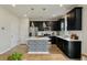 Modern kitchen features dark cabinetry, stainless steel appliances, and stylish central island at 163 Cypress Plantation Rd, Moncks Corner, SC 29461