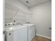 Clean laundry room featuring a white washer and dryer with a wire shelf at 163 Cypress Plantation Rd, Moncks Corner, SC 29461