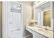 Well-lit bathroom with a sink vanity, large mirror, and a shower with a white curtain at 1708 Eallystockert Rd, Charleston, SC 29414