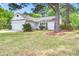 Charming, bright, one story home featuring an attached garage and green lawn at 1708 Eallystockert Rd, Charleston, SC 29414