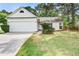 Bright, one story home featuring an attached garage, a green lawn, and a quaint front garden at 1708 Eallystockert Rd, Charleston, SC 29414