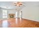 A spacious living room with wood floors, a brick fireplace, and plenty of natural light at 1708 Eallystockert Rd, Charleston, SC 29414