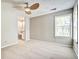 Bright main bedroom featuring a ceiling fan, neutral walls, and an ensuite bathroom at 1708 Eallystockert Rd, Charleston, SC 29414