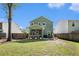 Spacious backyard features a well-maintained lawn, a fenced perimeter, and a screened porch area at 1723 Indaba Way, Charleston, SC 29414