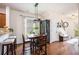 Inviting dining area featuring hardwood floors, stylish lighting, and an adjacent kitchen area at 1723 Indaba Way, Charleston, SC 29414