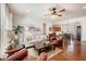 Inviting living room with hardwood floors, a ceiling fan, and an open layout to the kitchen and dining area at 1723 Indaba Way, Charleston, SC 29414