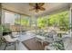 Relaxing screened porch with a ceiling fan, comfortable seating, and views of the private backyard at 1723 Indaba Way, Charleston, SC 29414
