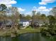 Scenic aerial view of the property showcasing a lush backyard, waterfront access, and mature trees at 1749 James Basford Pl, Mount Pleasant, SC 29466
