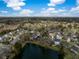Wide aerial view showing the community with a pond and marsh with the homes nestled between mature trees at 1749 James Basford Pl, Mount Pleasant, SC 29466