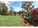 Backyard with pond view and whimsical frog statue next to a bench at 1749 James Basford Pl, Mount Pleasant, SC 29466