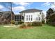 Expansive backyard featuring a screened porch, fire pit, and lush landscaping creating an ideal outdoor living space at 1749 James Basford Pl, Mount Pleasant, SC 29466