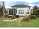 View of a spacious backyard showcasing a fire pit, stone pathway, and attractive landscaping details at 1749 James Basford Pl, Mount Pleasant, SC 29466