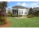 Spacious backyard featuring a fire pit and a view of the home's exterior at 1749 James Basford Pl, Mount Pleasant, SC 29466