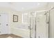 Modern bathroom featuring a soaking tub, glass shower, and neutral color palette at 1749 James Basford Pl, Mount Pleasant, SC 29466