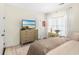 Bedroom showcasing a dresser with a TV, white trim, and natural light with warm tones at 1749 James Basford Pl, Mount Pleasant, SC 29466
