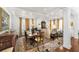 Inviting dining area with coffered ceilings, an elegant table setting, and beautiful decor at 1749 James Basford Pl, Mount Pleasant, SC 29466
