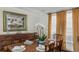 Formal dining room featuring a dark wood table, seating for six, and elegant decor creating a refined ambiance at 1749 James Basford Pl, Mount Pleasant, SC 29466
