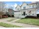 Elegant two-story home with a covered front porch, double garage, and meticulously manicured lawn at 1749 James Basford Pl, Mount Pleasant, SC 29466